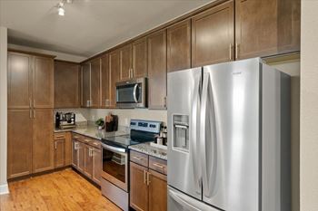 Kitchen with stainless steel refrigerator and cabinets